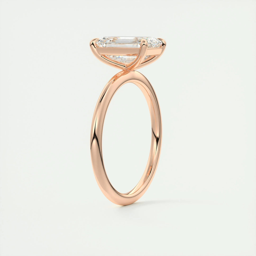 Lifestyle shot of emerald solitaire diamond ring on hand
