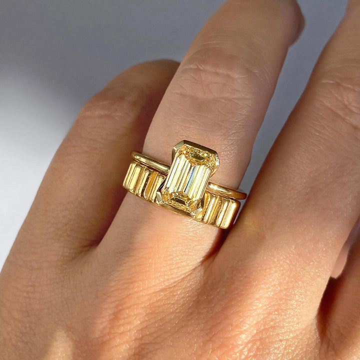 Emerald cut solitaire engagement ring with IGI certified center diamond