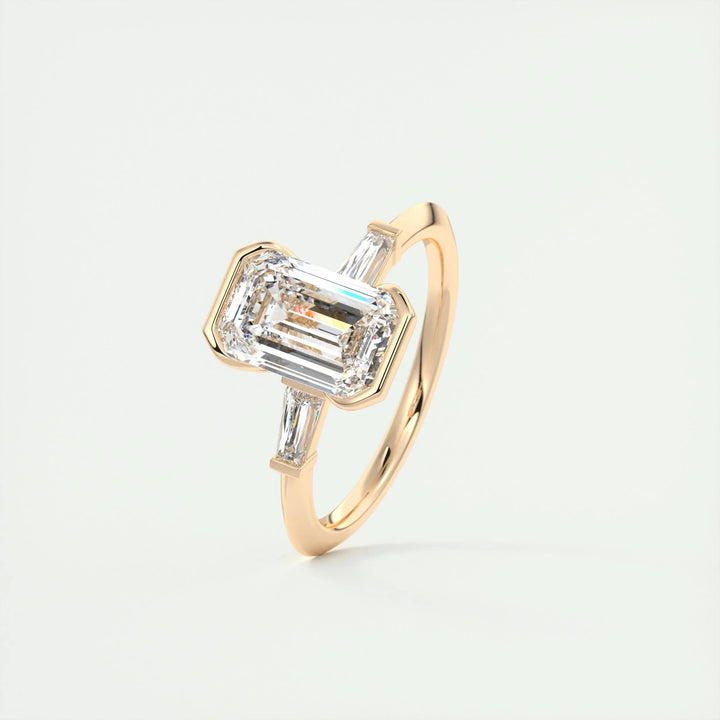 Emerald three stone engagement ring photographed in natural light