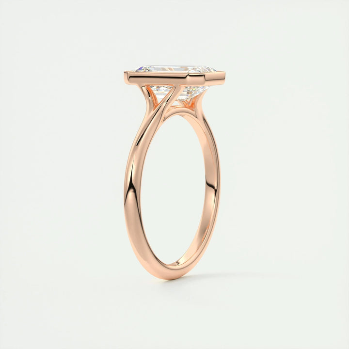 Emerald bezel engagement ring offered in gold and platinum