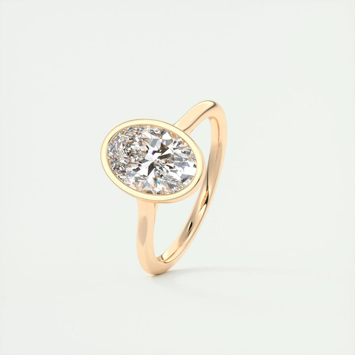 Oval bezel engagement ring offered in gold and platinum