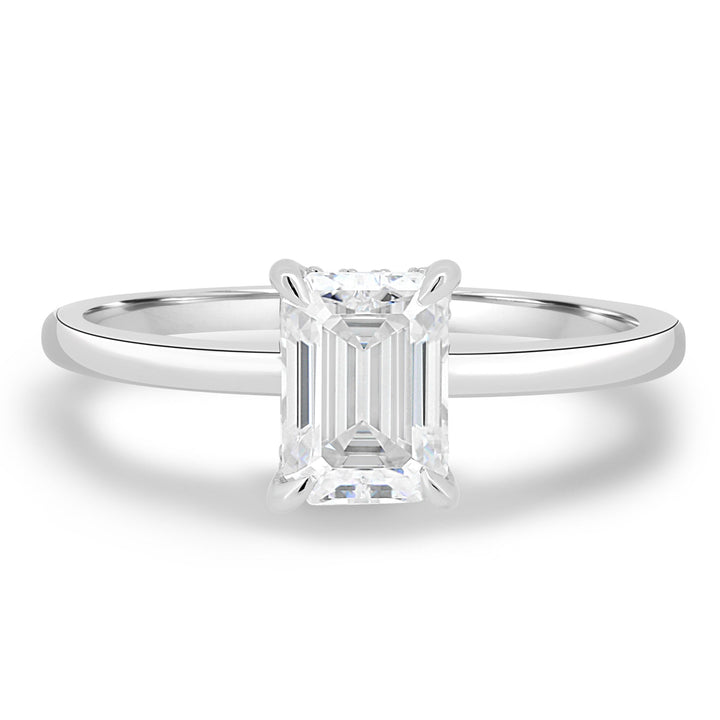 Emerald cut engagement ring shown with authenticity certificate