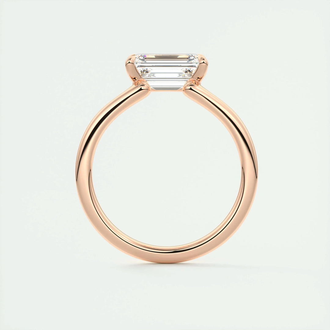 Emerald solitaire diamond engagement ring available in multiple metals