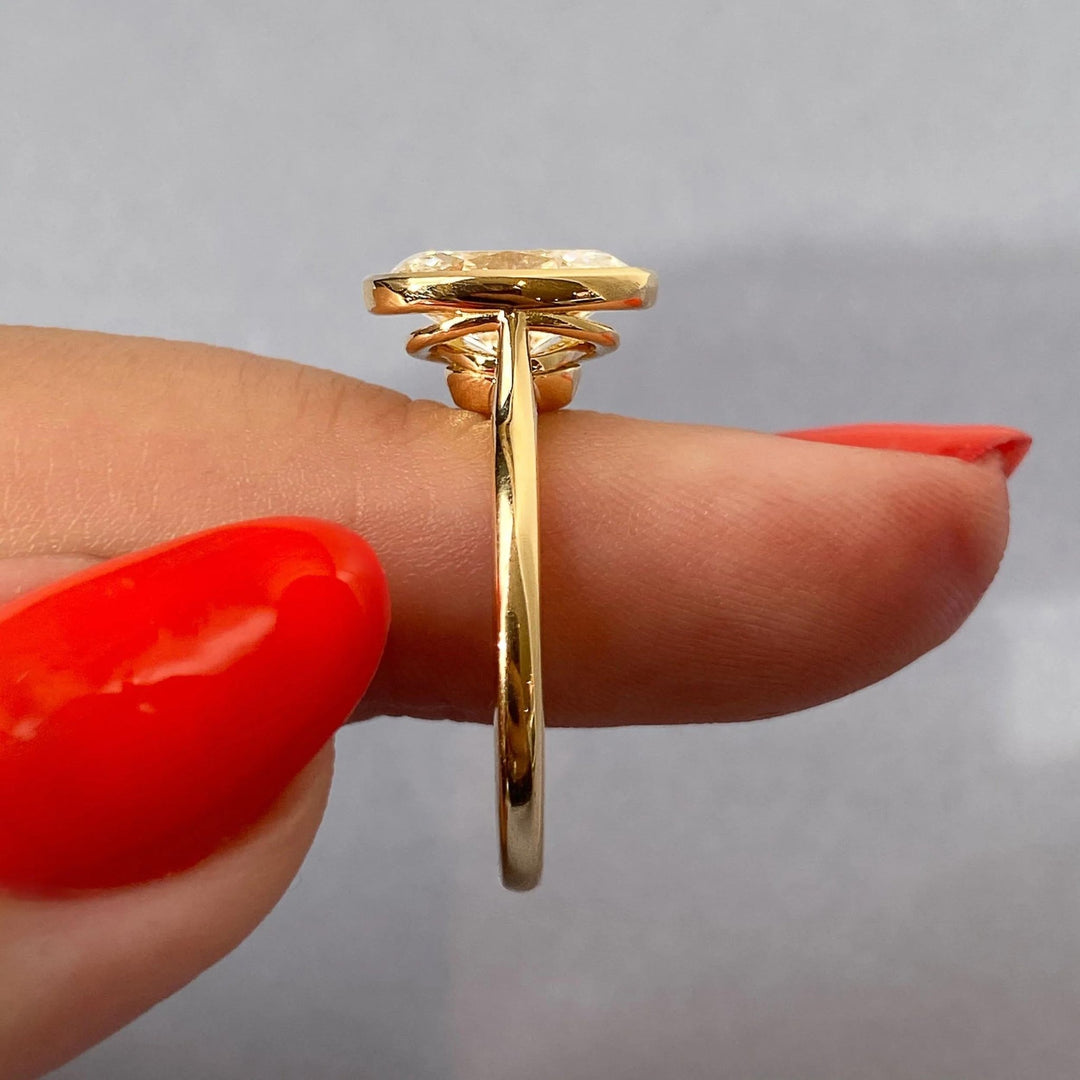 Oval bezel engagement ring finished in polished solid gold