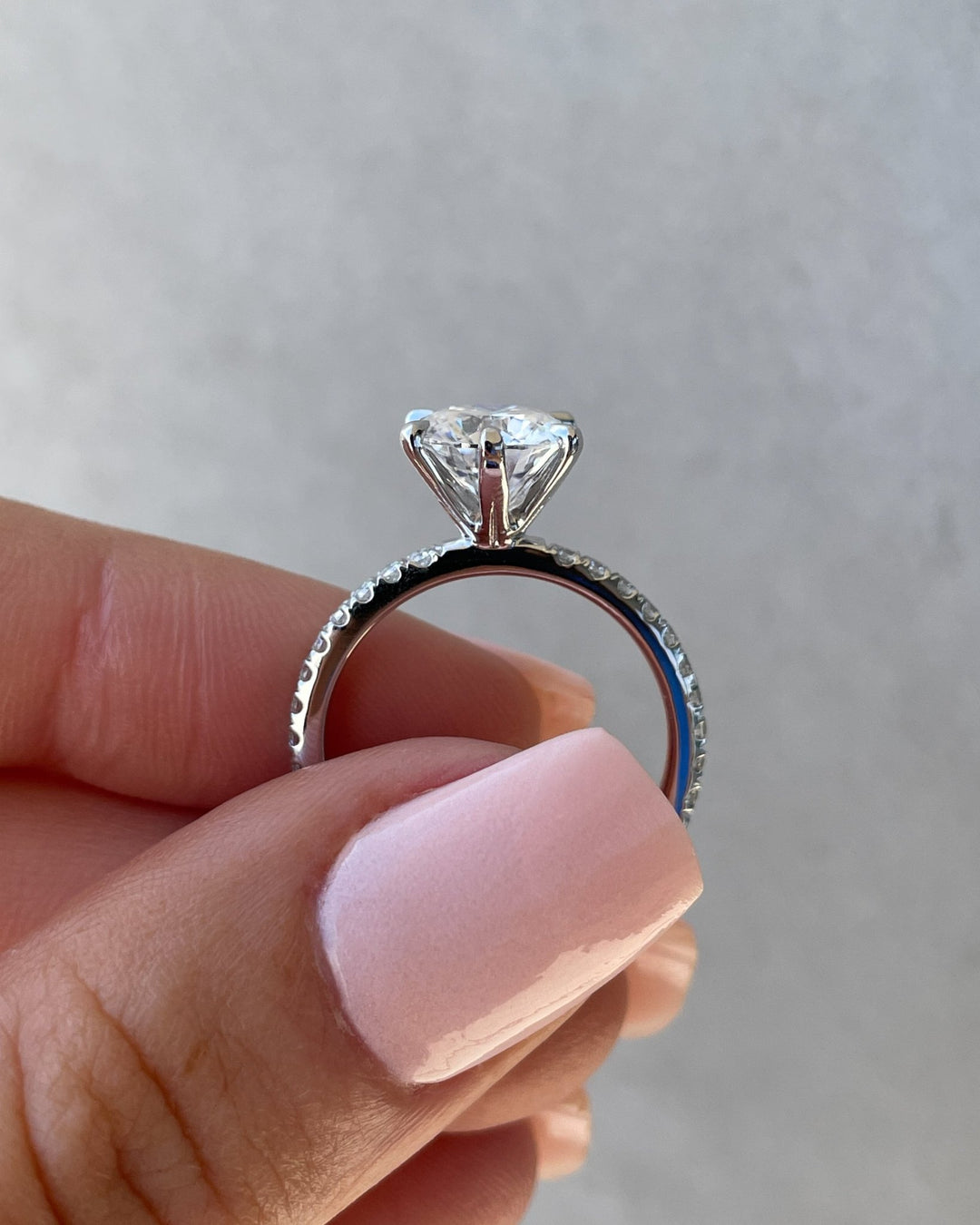 Round pave engagement ring shown on hand for true-to-life sizing