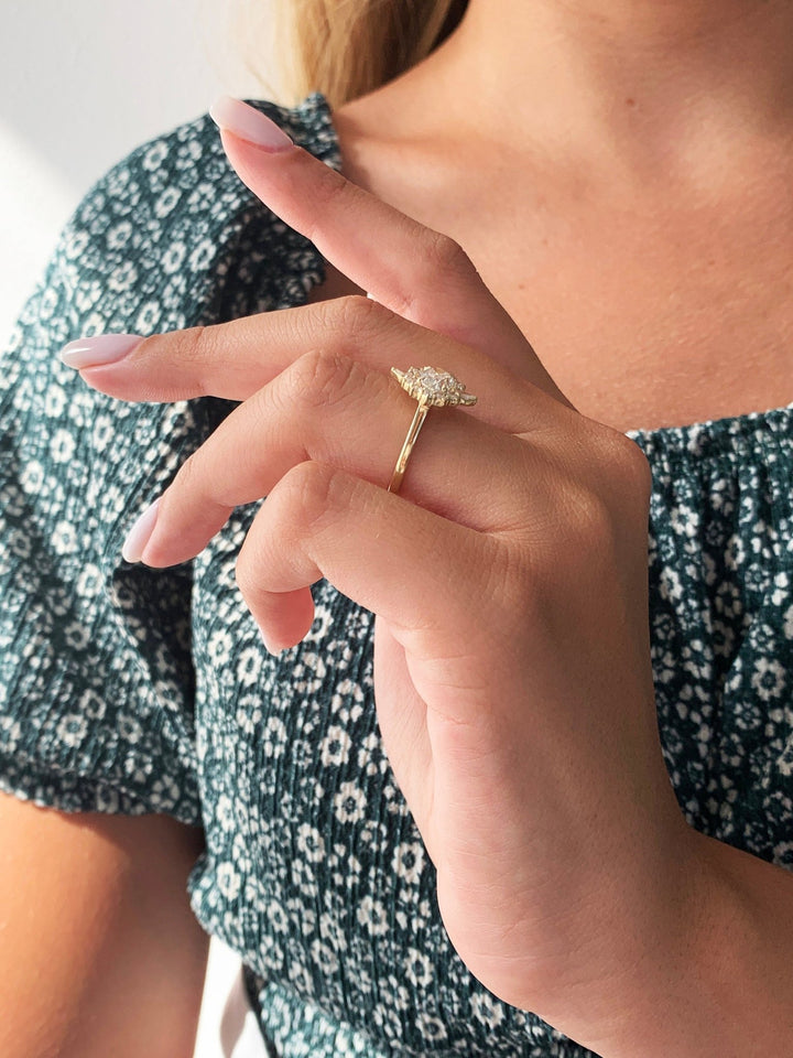Detailed close-up of oval halo diamond engagement ring