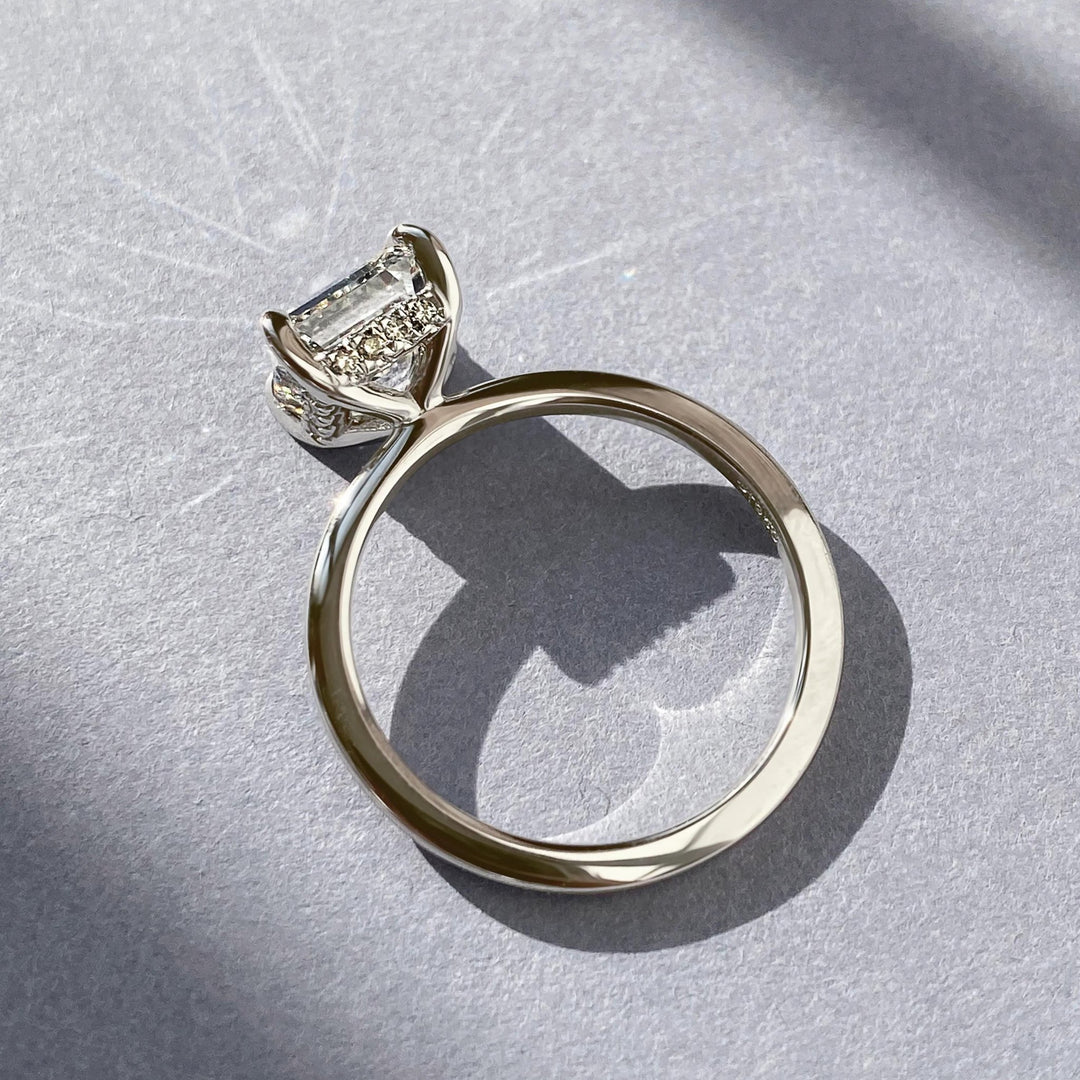 Detailed close-up of cushion hidden halo diamond engagement ring
