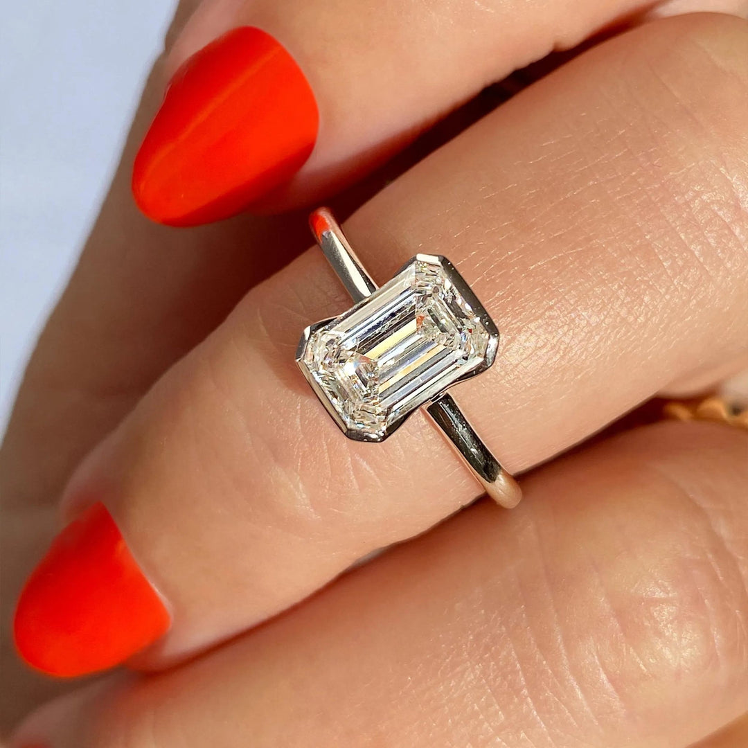 Emerald solitaire lab grown diamond ring fitted on finger