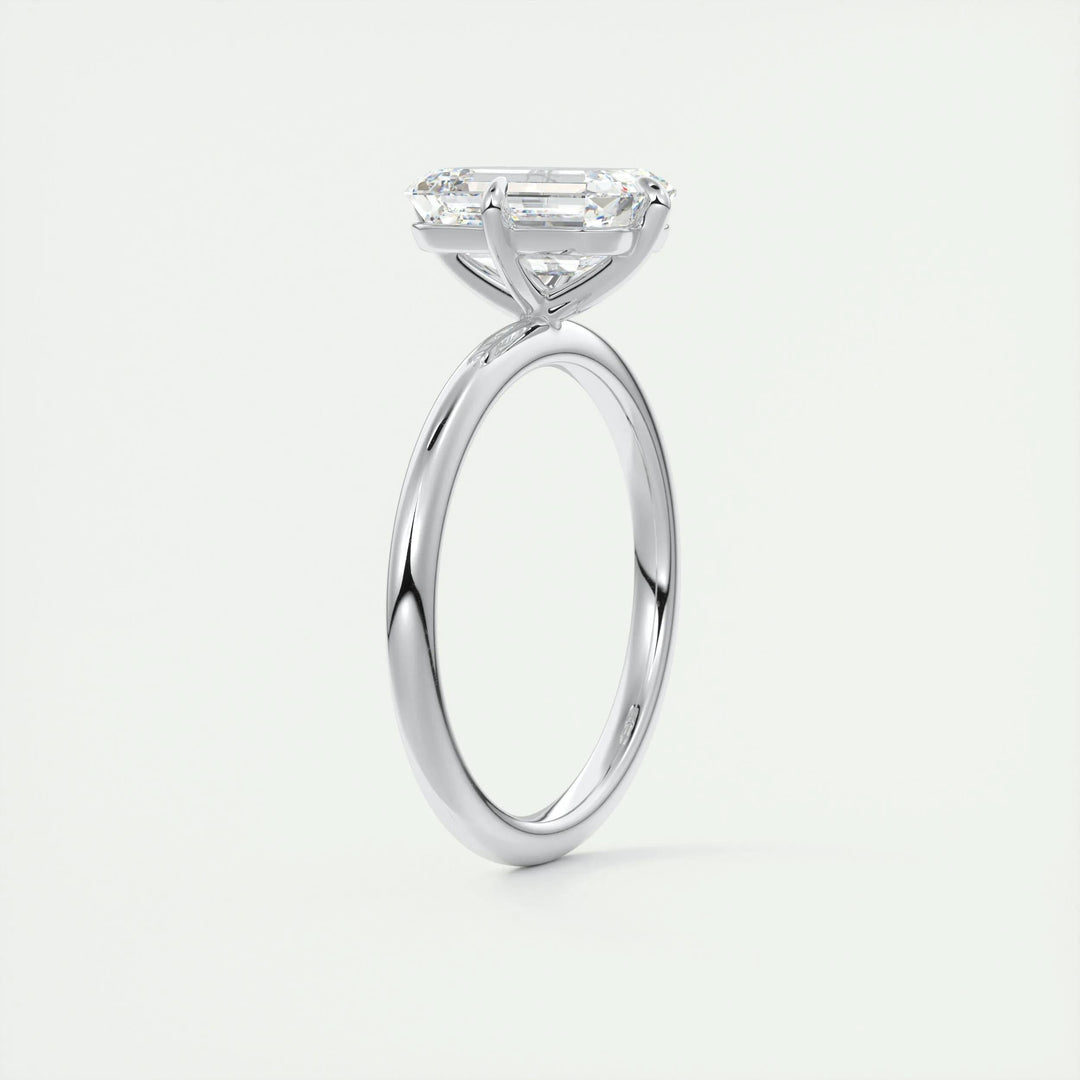 Emerald solitaire engagement ring photographed in natural light