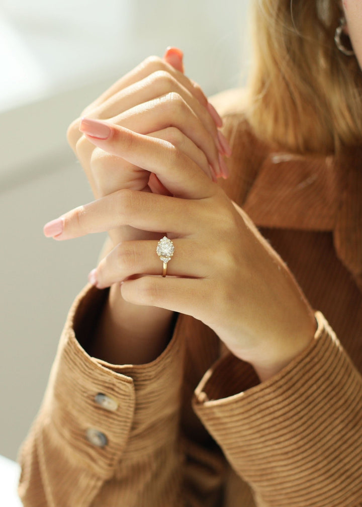 Round cut cluster engagement ring shown in real-life wear