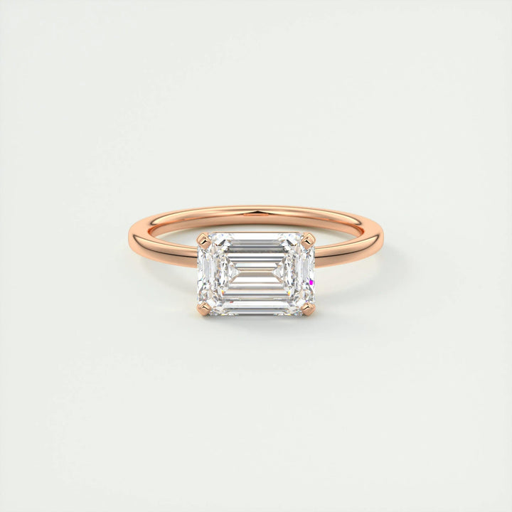 Emerald east west diamond ring presented in signature gift packaging