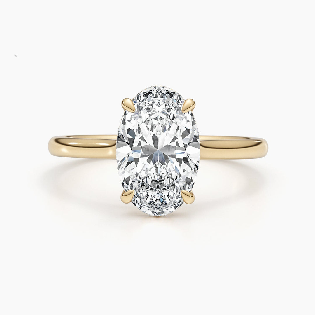 Oval hidden halo engagement ring finished in polished solid gold