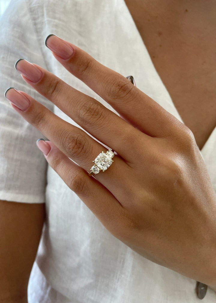 Fine craftsmanship detail on cushion three stone engagement ring