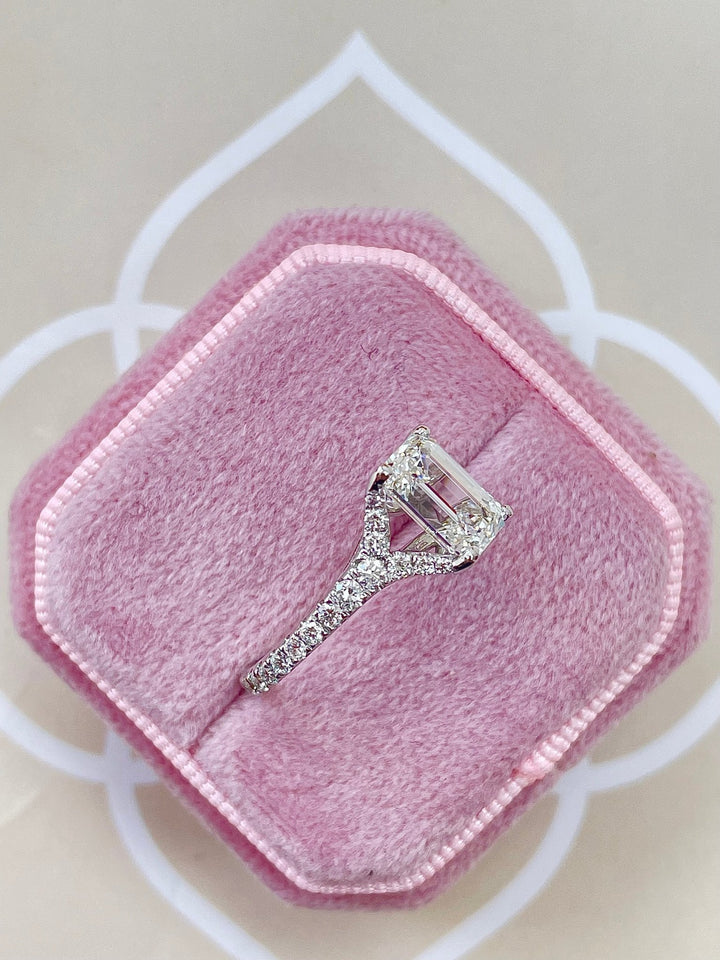 Emerald cut split shank engagement ring shown in real-life wear