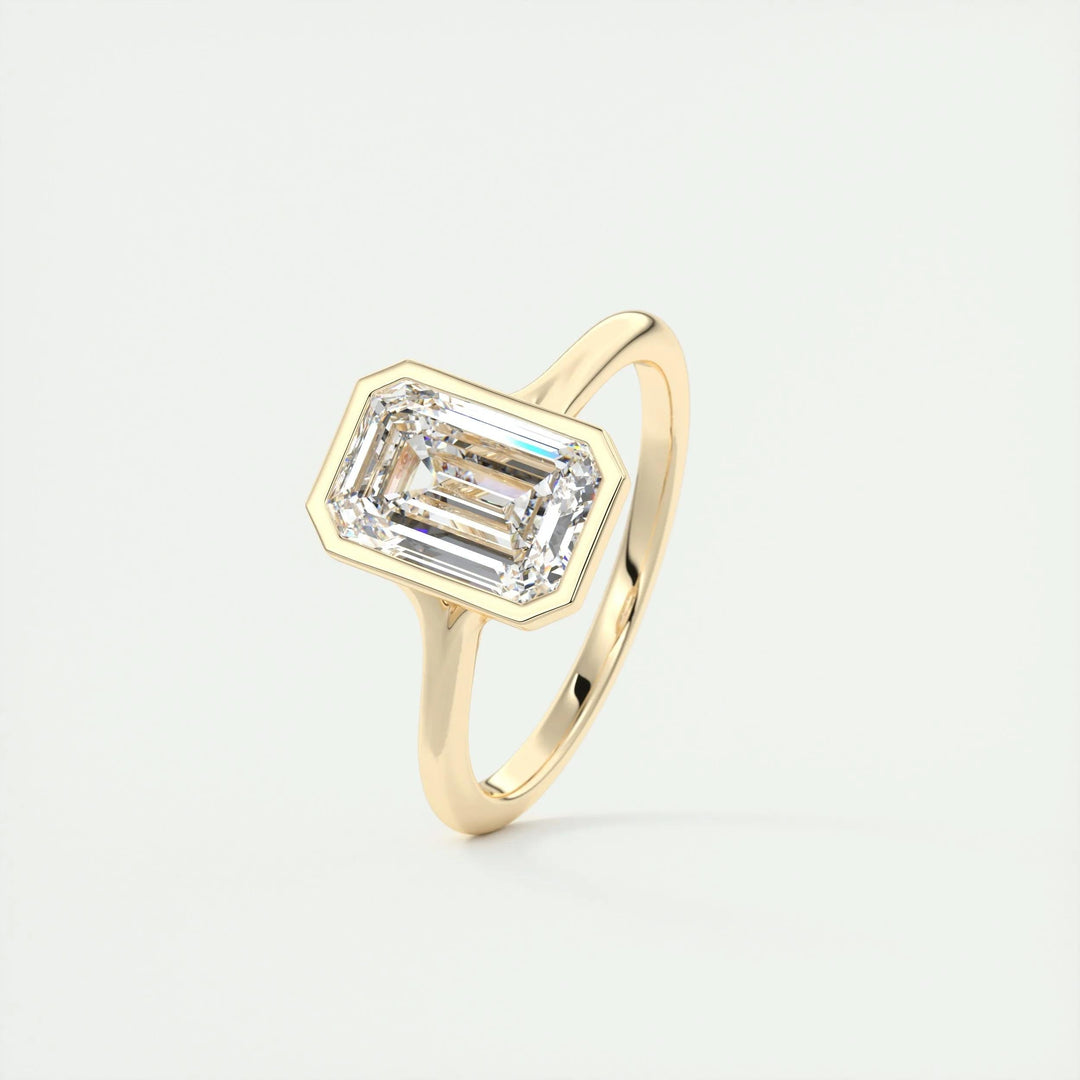 Lifestyle shot of emerald bezel diamond ring on hand