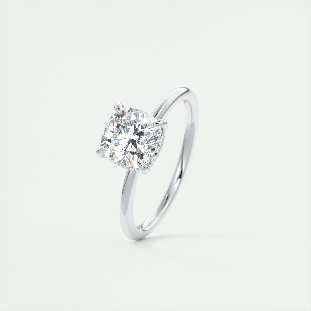 Cushion hidden halo diamond ring displayed on jewelry stand