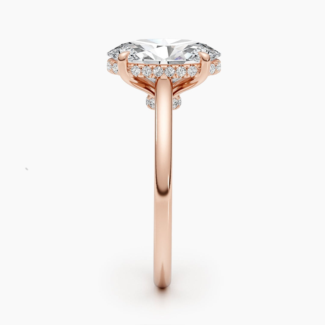 Oval hidden halo diamond ring displayed on jewelry stand