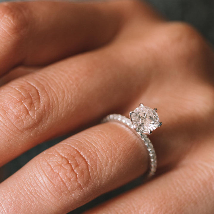 Round pave engagement ring viewed from the side