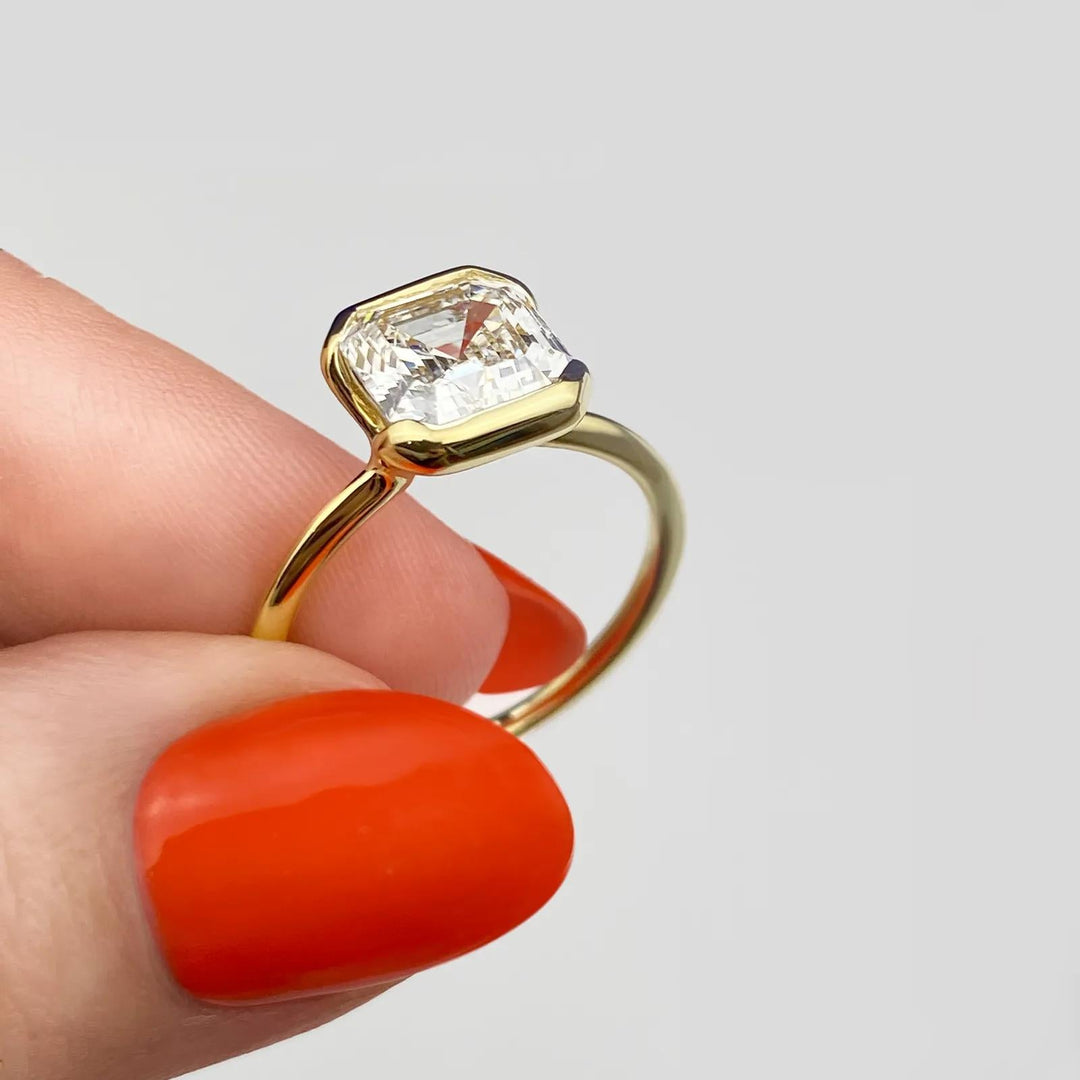 Asscher solitaire engagement ring close-up showing F-/VS1 diamond clarity