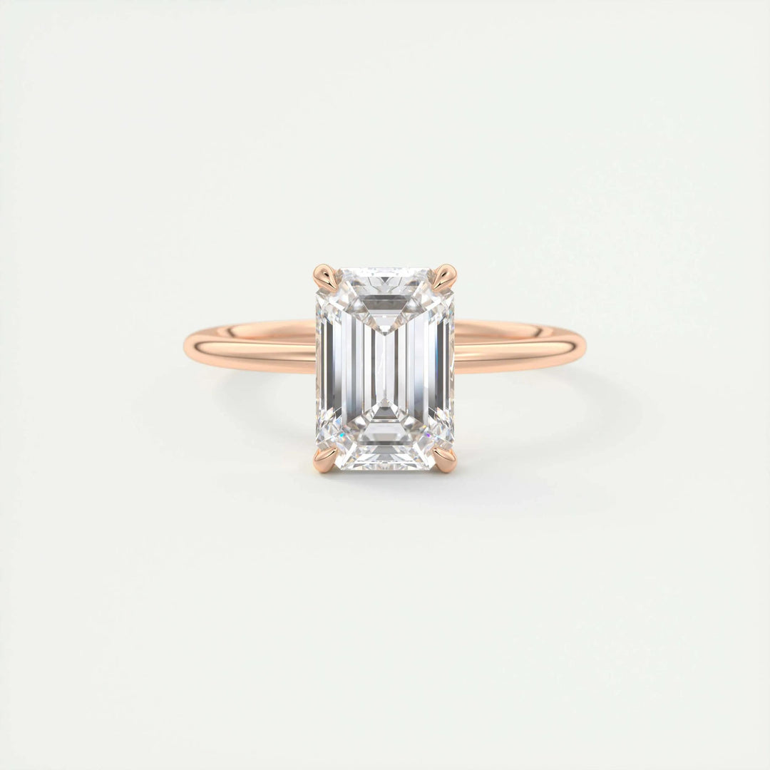 Emerald solitaire engagement ring viewed from the side