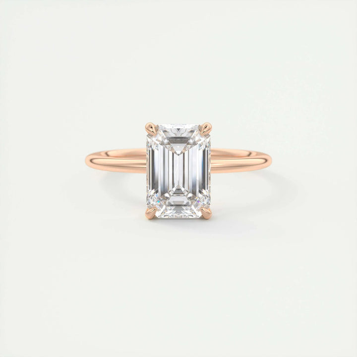 Emerald solitaire engagement ring viewed from the side