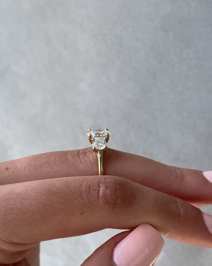 Detailed close-up of oval three stone diamond engagement ring