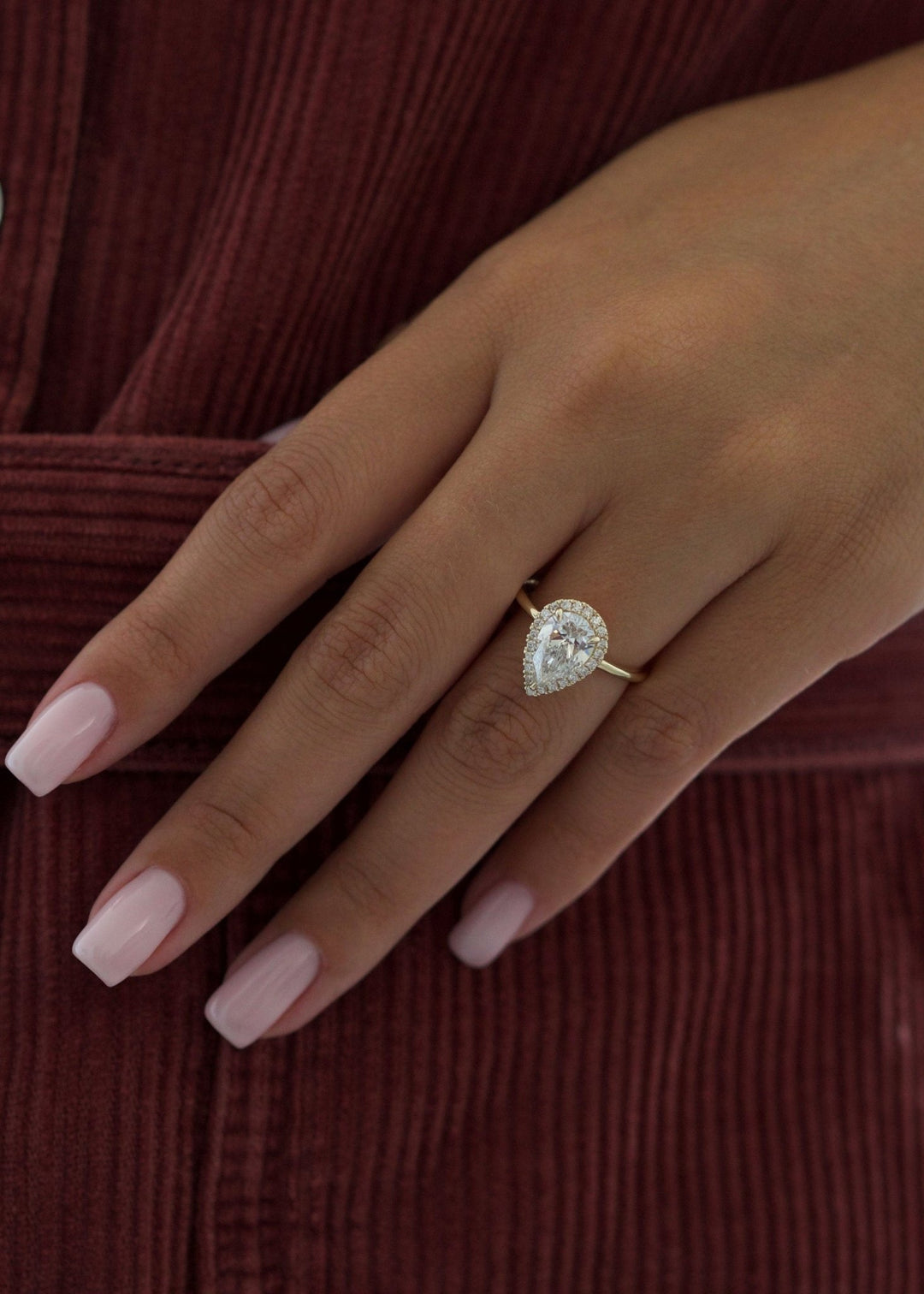 Pear cut engagement ring shown with authenticity certificate