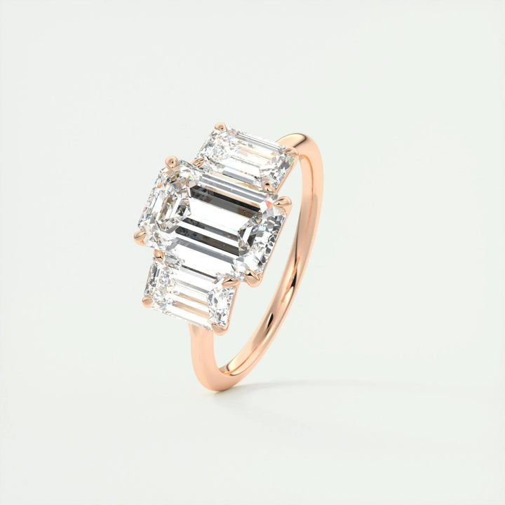 Lifestyle shot of emerald three stone diamond ring on hand