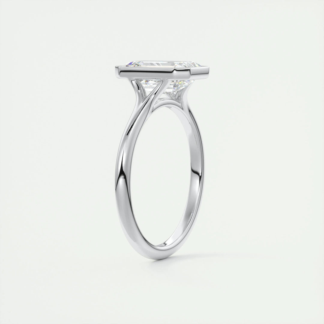 Emerald bezel engagement ring viewed from the side