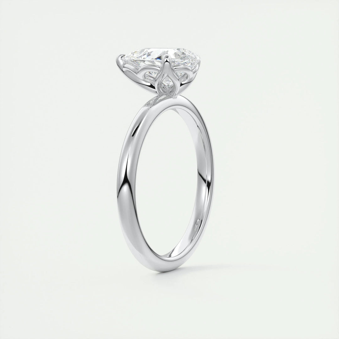 Pear solitaire engagement ring close-up showing F-/VS1 diamond clarity