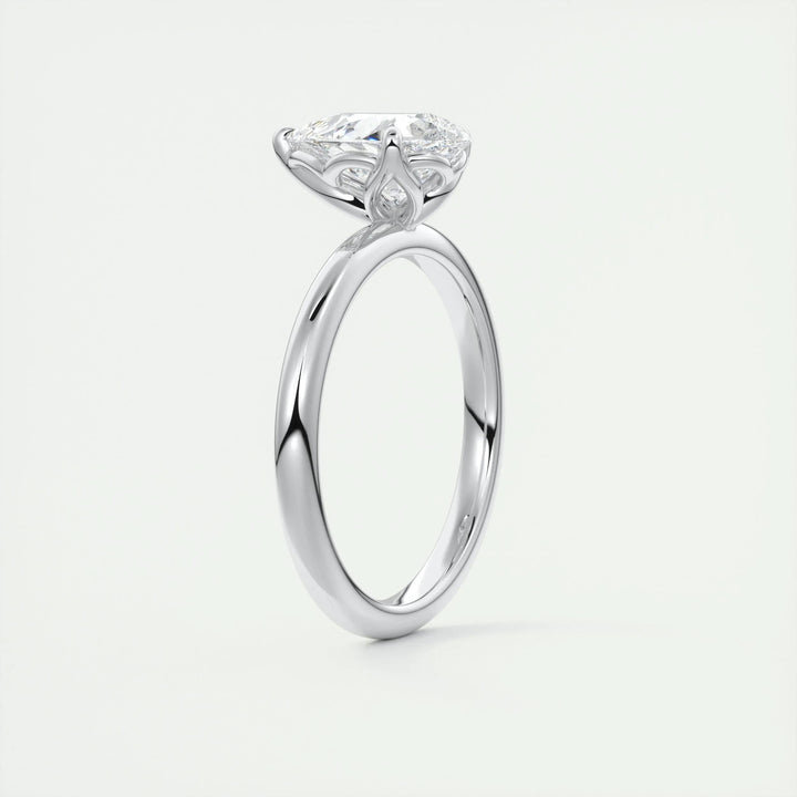Pear solitaire engagement ring close-up showing F-/VS1 diamond clarity