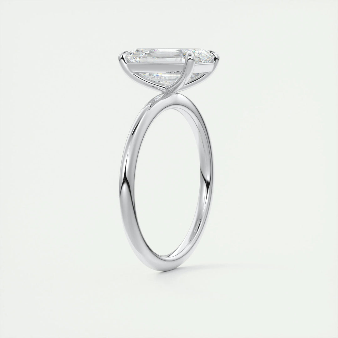 Emerald solitaire engagement ring close-up highlighting diamond sparkle