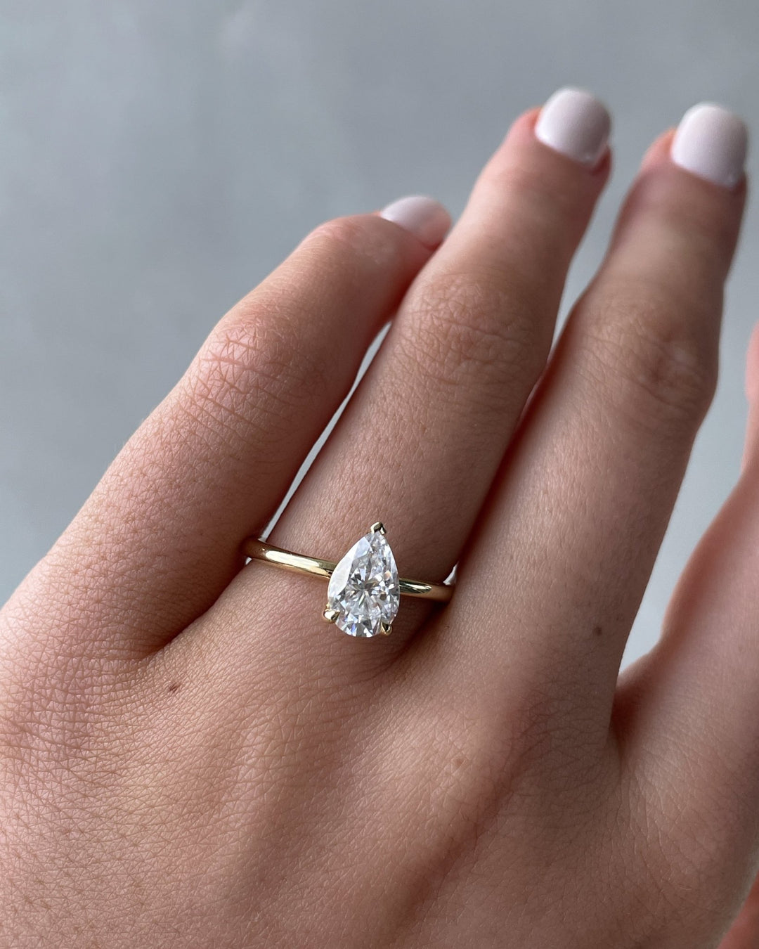 Detailed close-up of pear solitaire diamond engagement ring