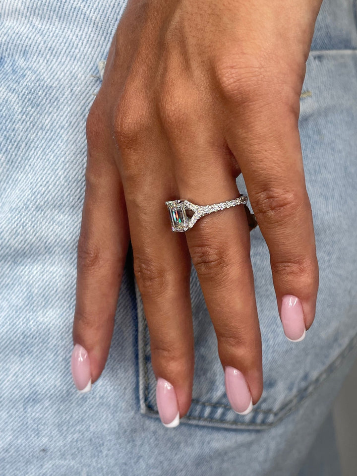 Emerald cut split shank engagement ring with IGI certified center diamond