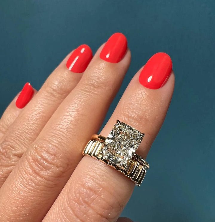 Radiant solitaire engagement ring close-up showing F-/VS1 diamond clarity