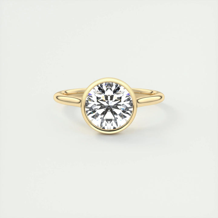 Round bezel engagement ring close-up showing F-/VS1 diamond clarity