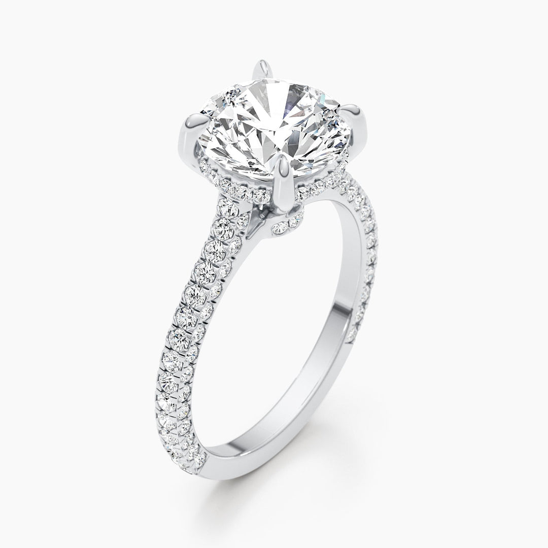 Round hidden halo diamond ring displayed on jewelry stand