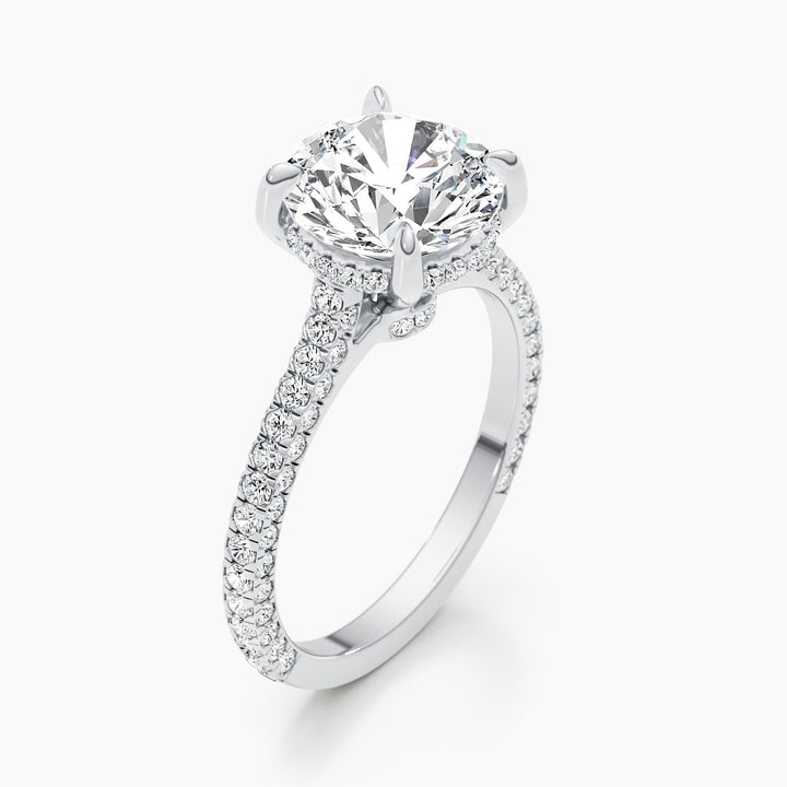 Round hidden halo diamond ring displayed on jewelry stand