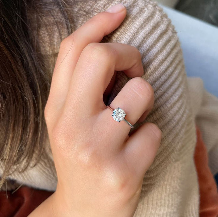Round solitaire engagement ring viewed from the side