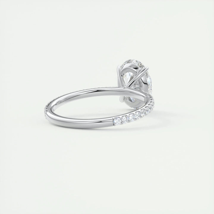 Close-up of oval cut center diamond in pave engagement ring