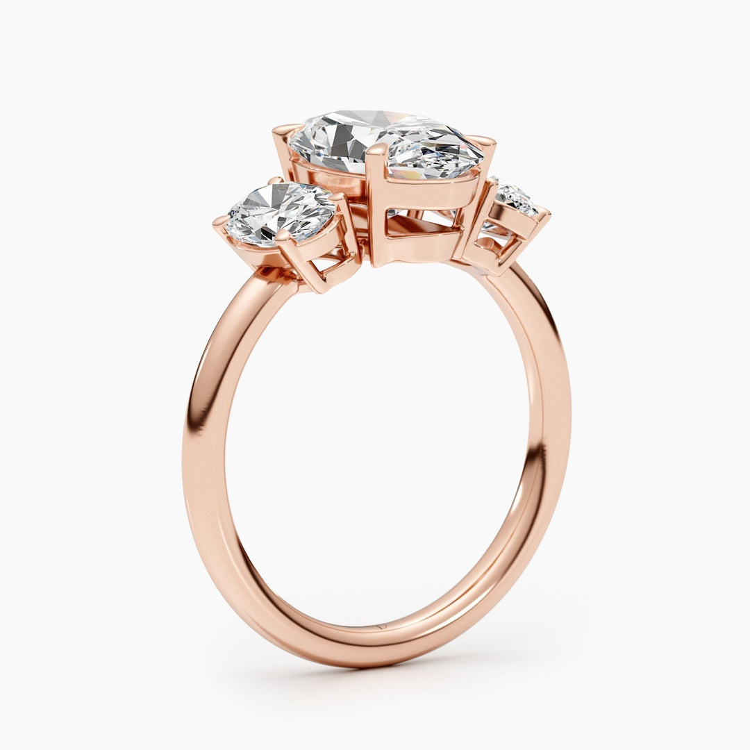 Macro shot of oval cut diamond facets in three stone ring setting