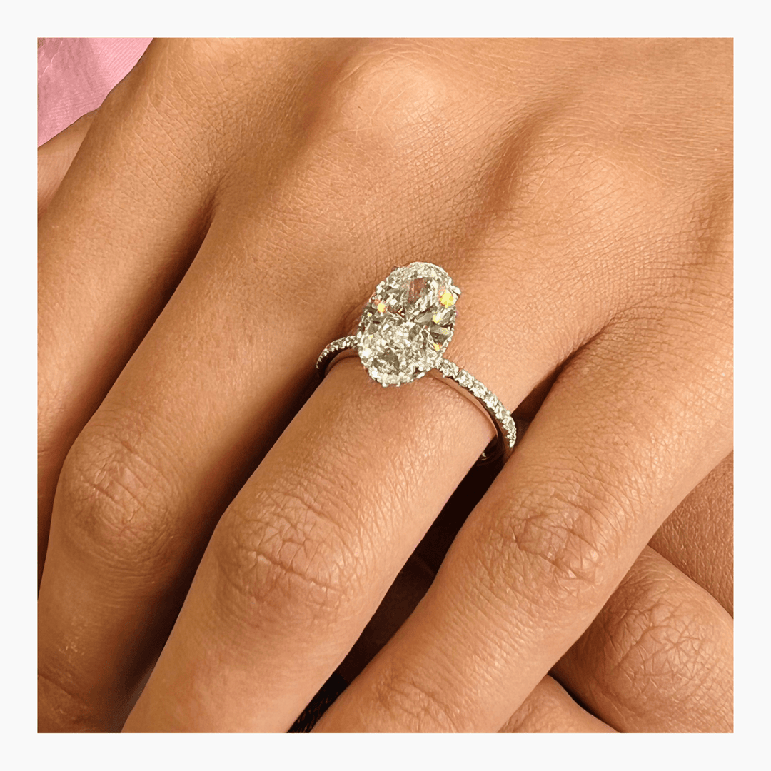 Oval pave ring set with an IGI graded diamond