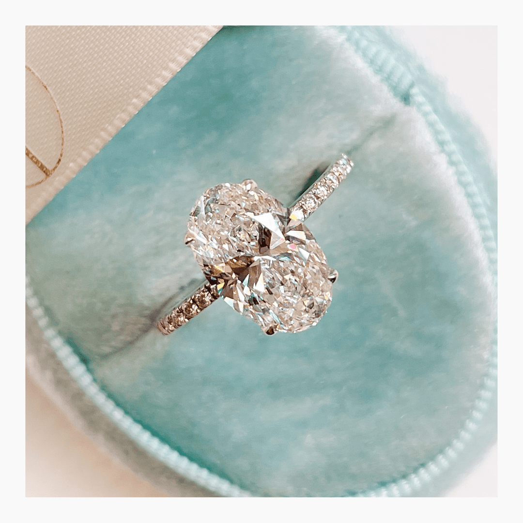 Certified oval cut diamond featured in pave engagement ring