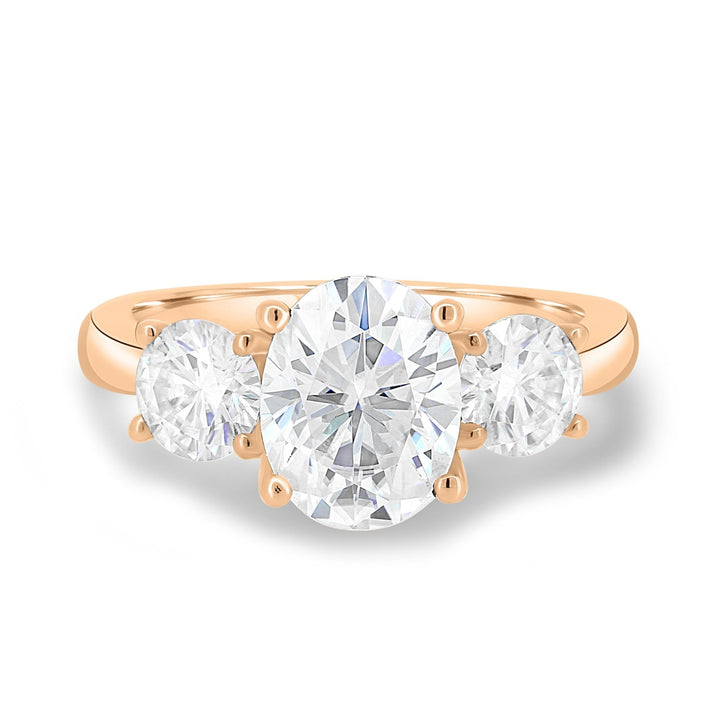 Oval three stone engagement ring shown on hand for true-to-life sizing