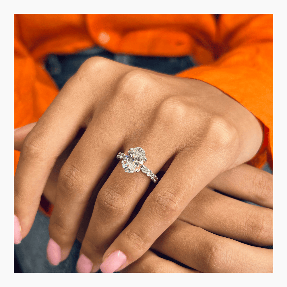 Oval cut pave engagement ring shown in real-life wear
