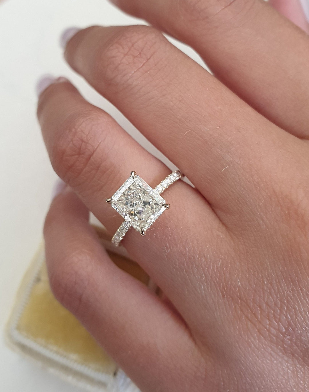 Macro shot of radiant cut diamond facets in pave ring setting
