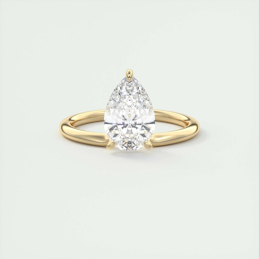 Pear solitaire engagement ring close-up showing F-/VS1 diamond clarity