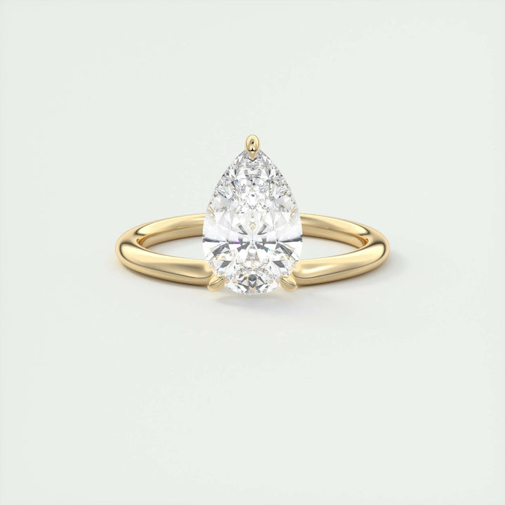 Pear solitaire engagement ring close-up showing F-/VS1 diamond clarity