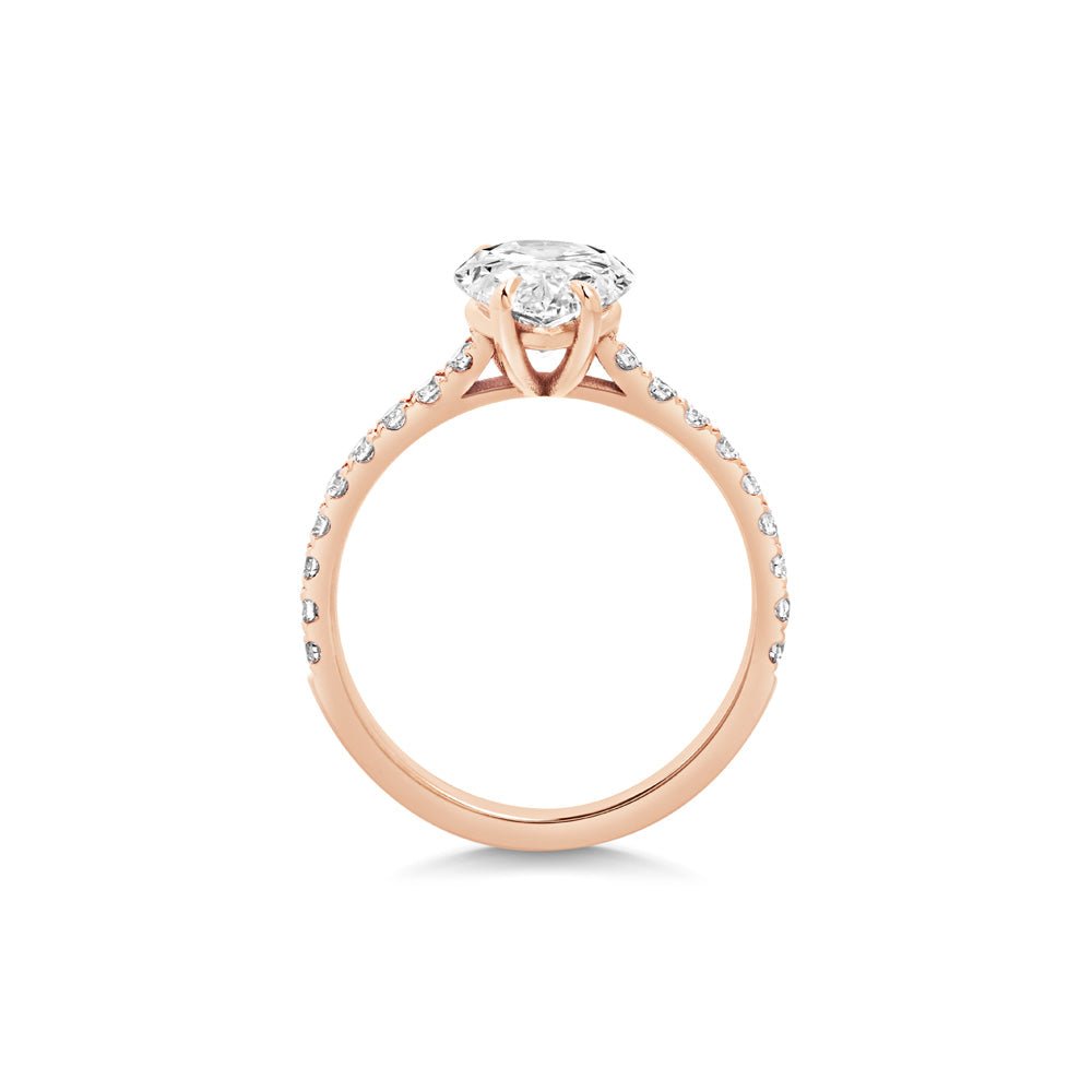 Pear pave engagement ring close-up showing F-/VS1 diamond clarity