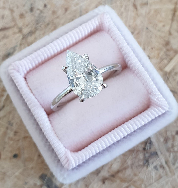 Premium pear cut hidden halo engagement ring crafted in solid gold